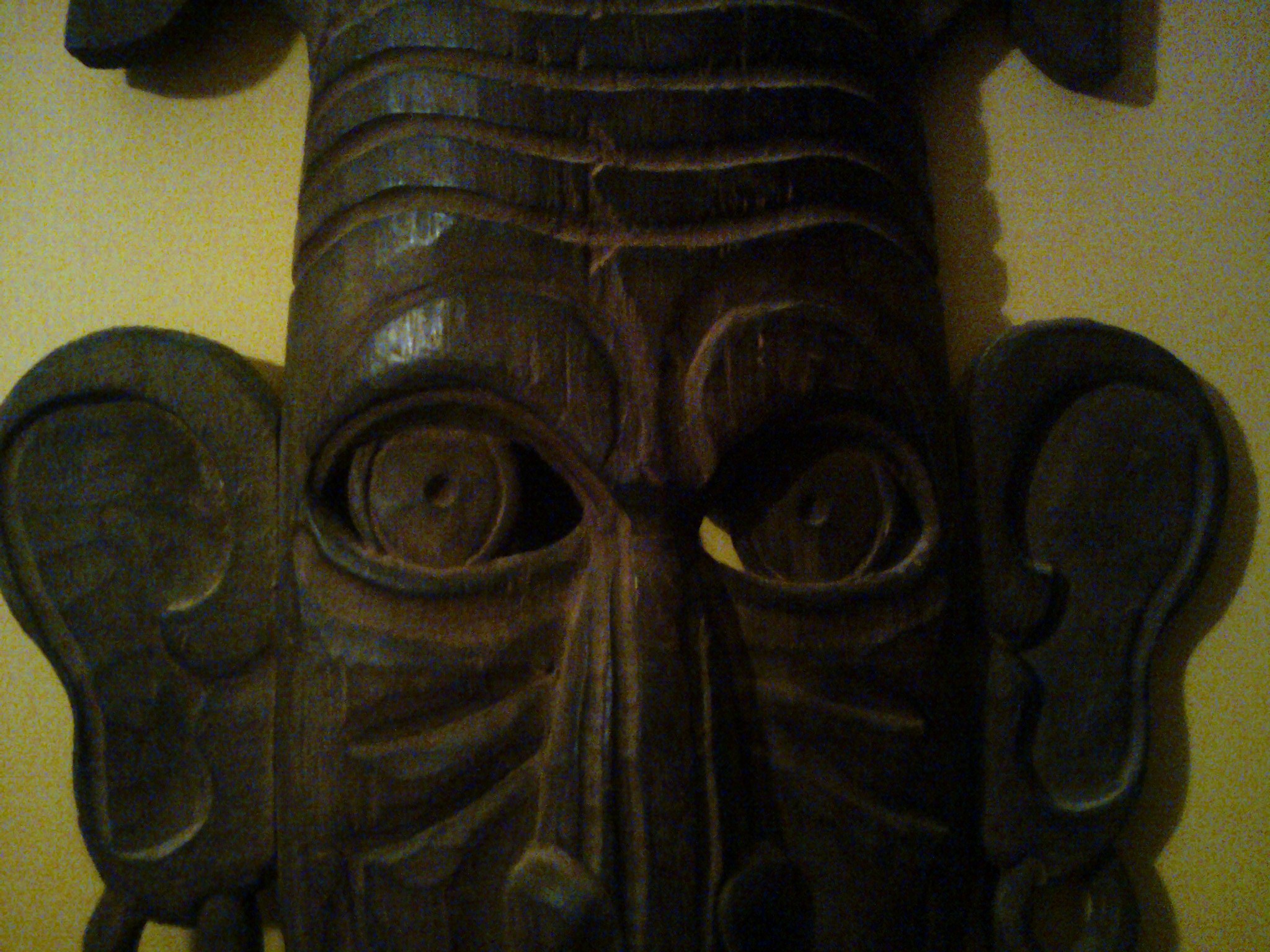 an odd looking mask with lots of shapes and eyes