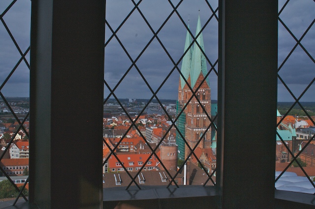 view of red roofs from inside a window