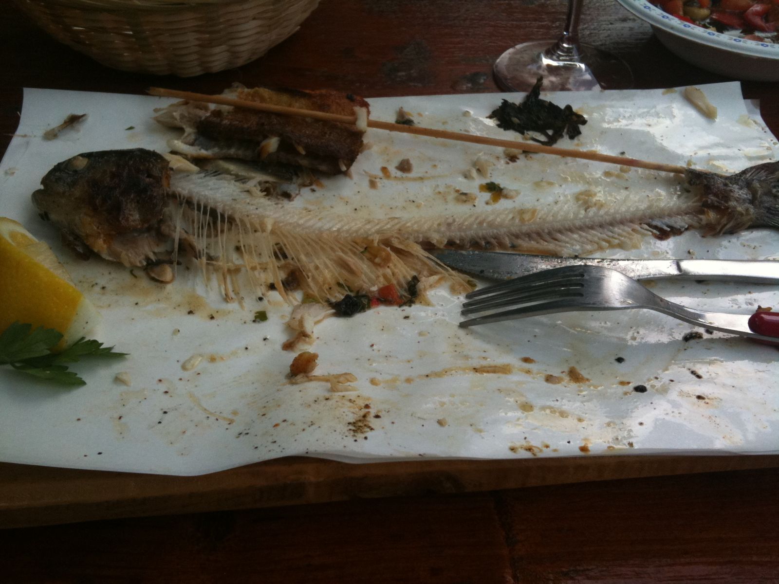 a wooden board topped with a dead fish