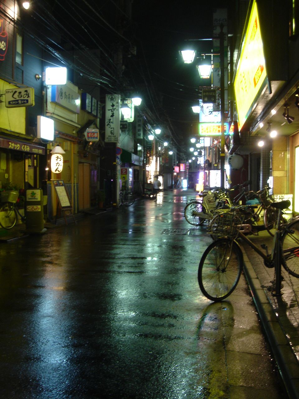 some bikes are standing on the side walk