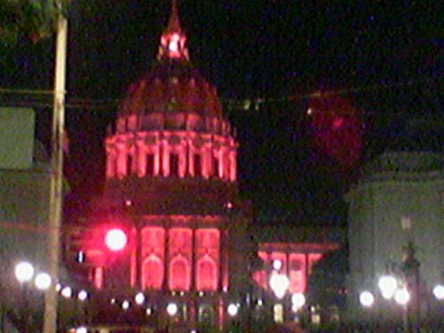the lights are red in the building with large dome