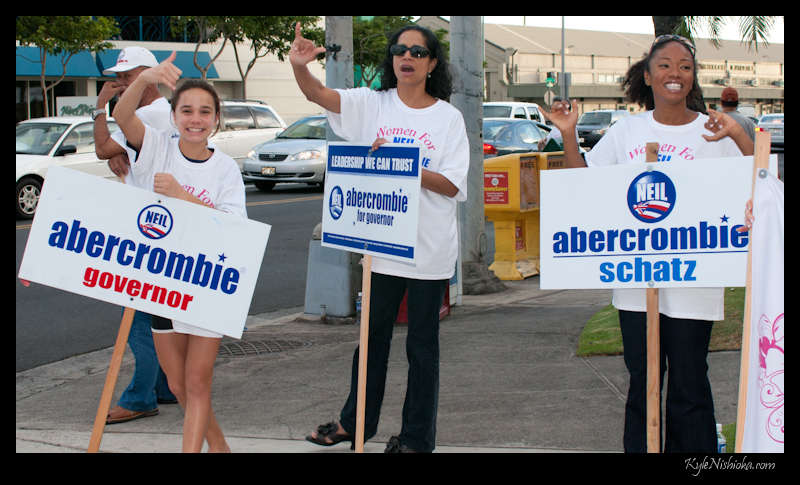 two people holding signs and two other people