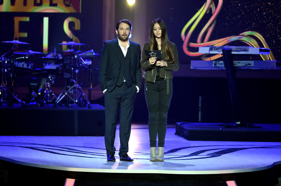 man and woman on stage at night during a concert