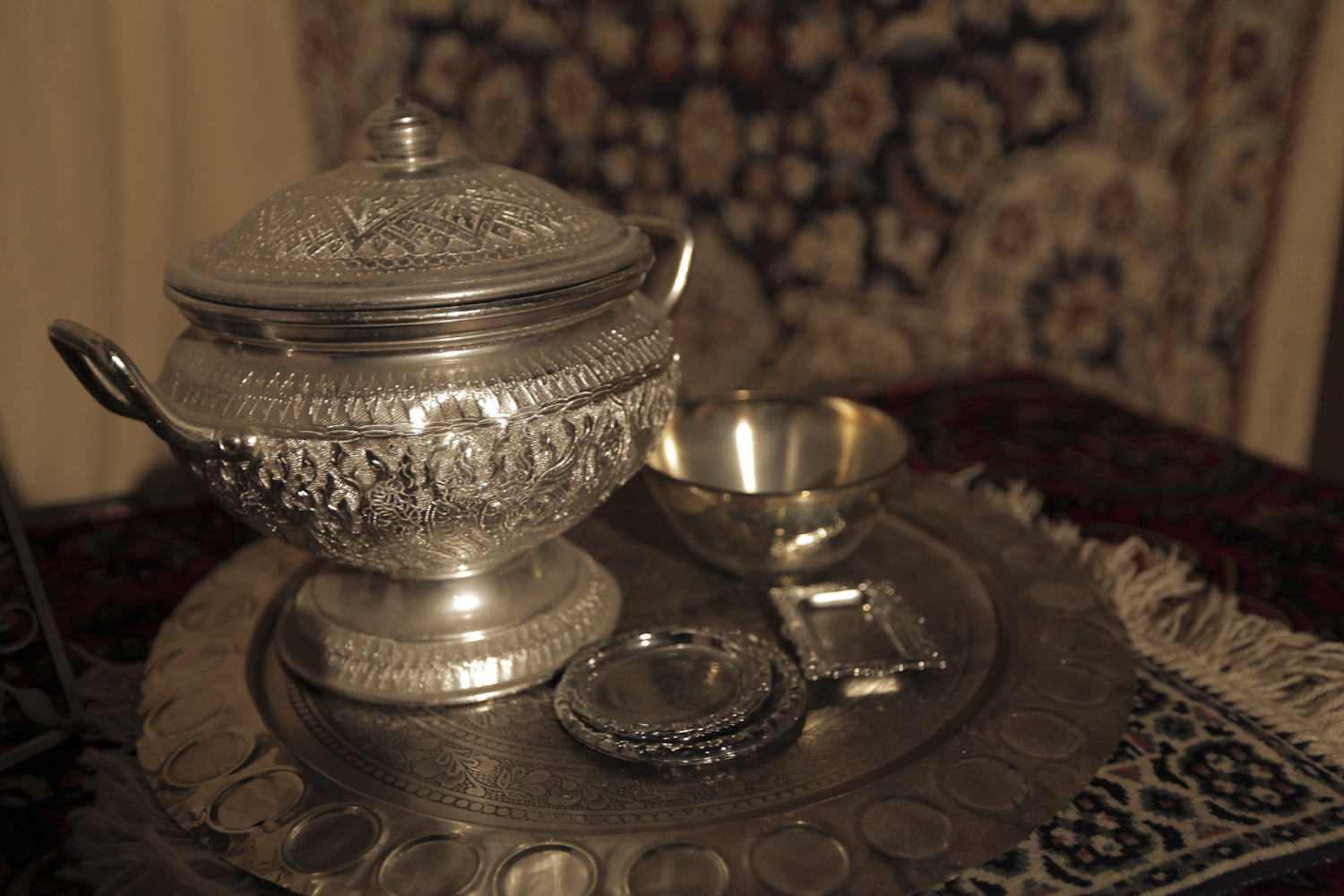 a silver plate has a tea pot and other accessories on it