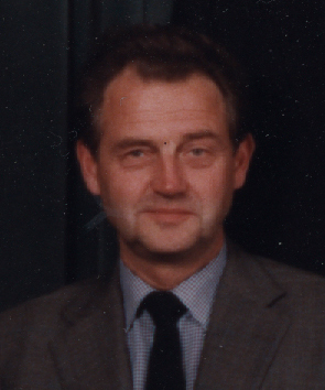 man with suit and tie in front of black background