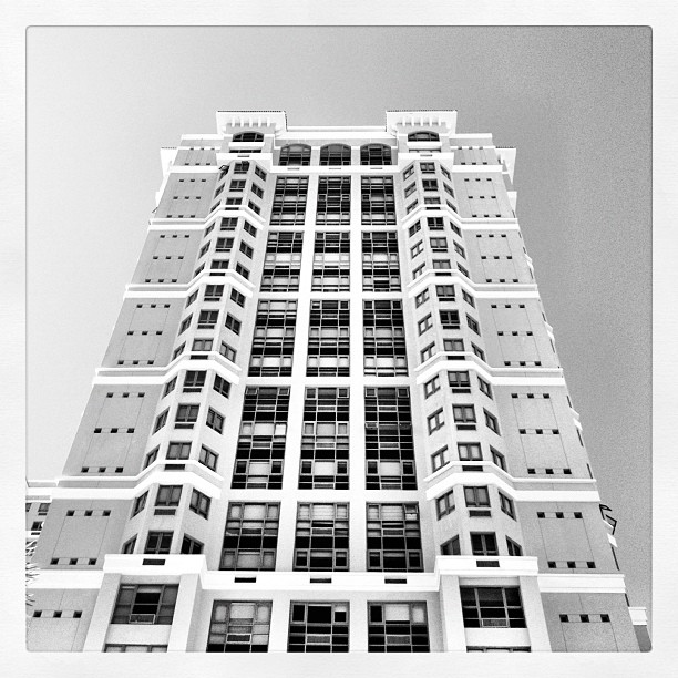 black and white pograph of high rise building with many windows