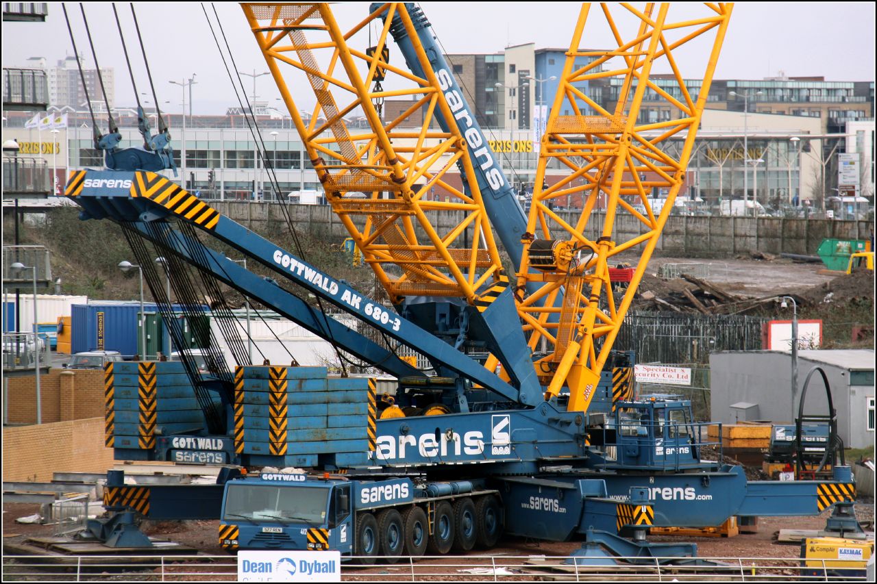 several cranes sit near each other on the ground