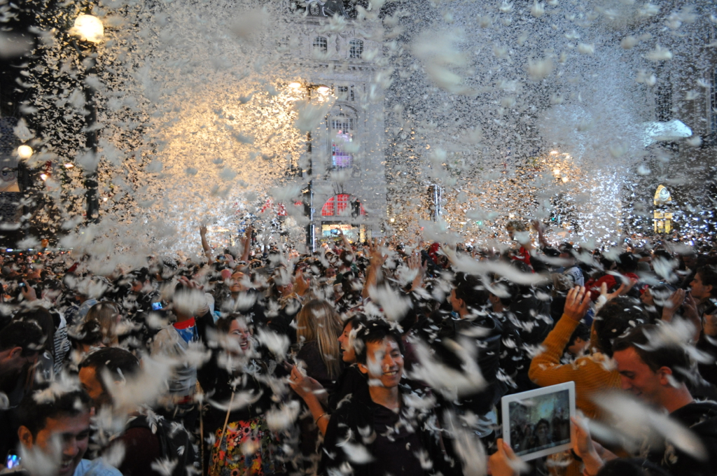 people with balloons and fireworks at a carnival