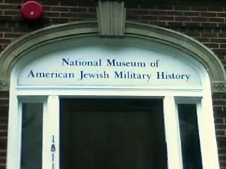 a historical museum with a red object above the window