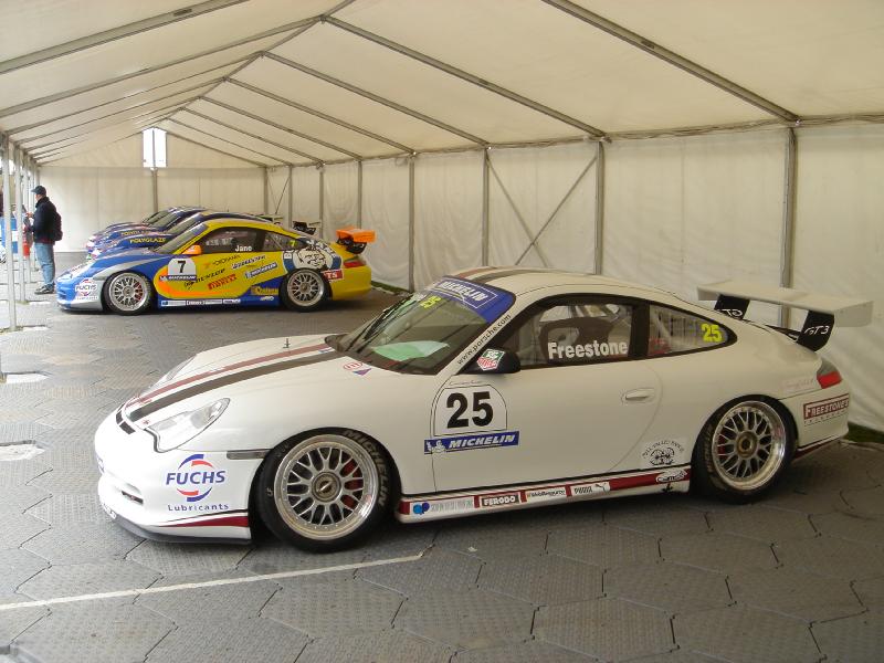 two porsche cars in a car show room