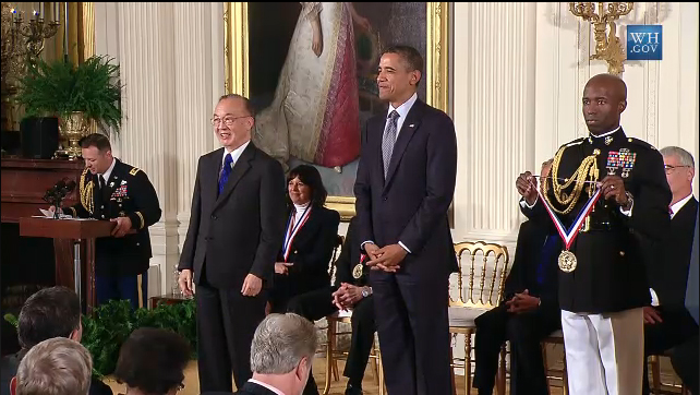 president obama standing in a white room with other men