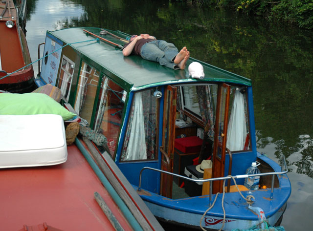 a man sleeping on the top of a boat