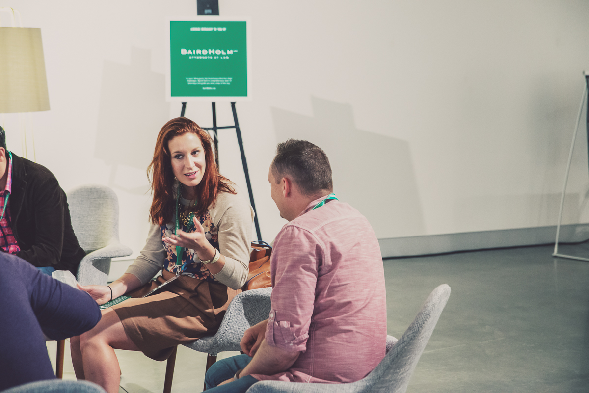 some people sitting in chairs at an event