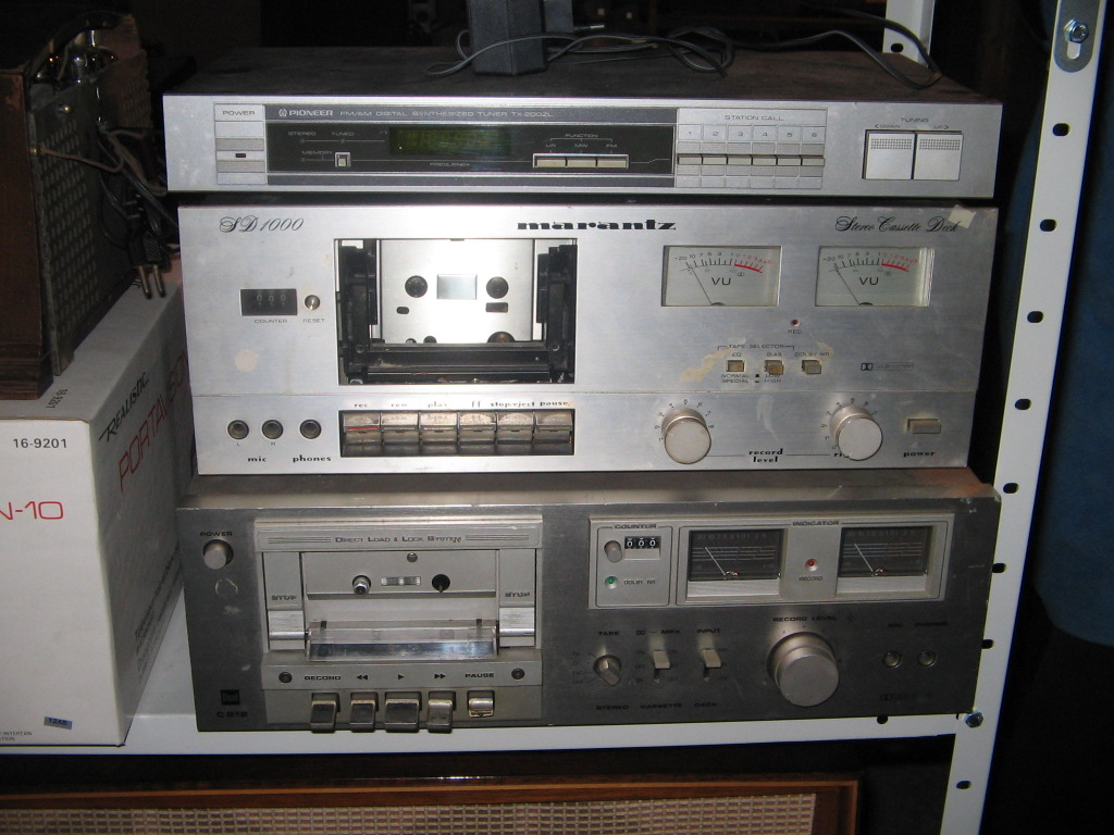 several stereo equipment stacked on top of each other