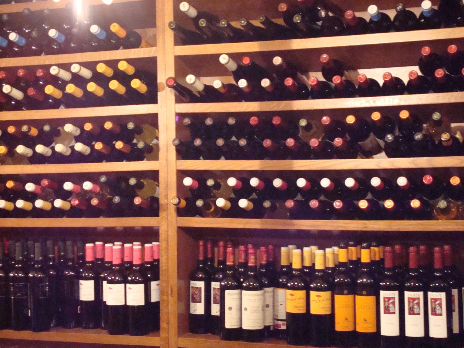 several bottles of wine sitting on display on a shelf