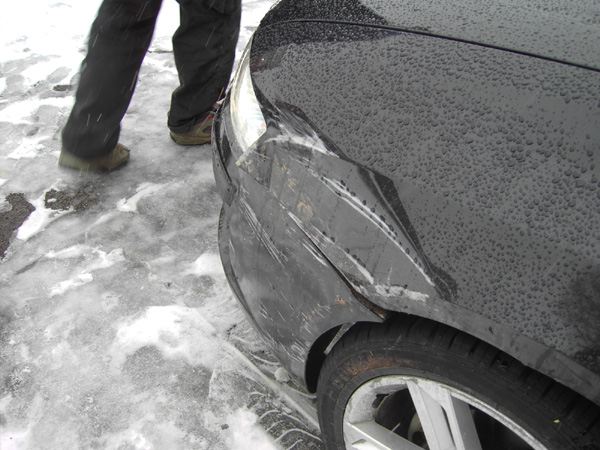 a close up of a car's windshield, with snow on the ground