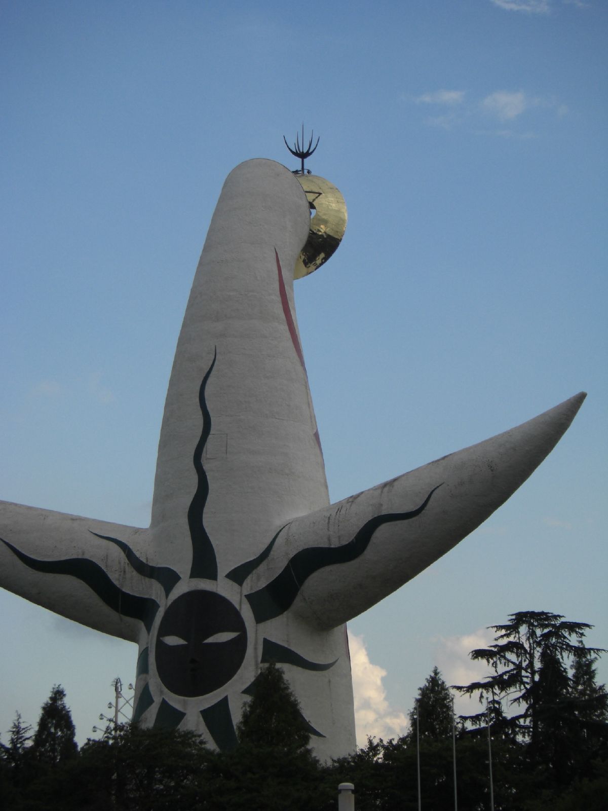 a large sculpture made out of cement with lots of trees on the sides