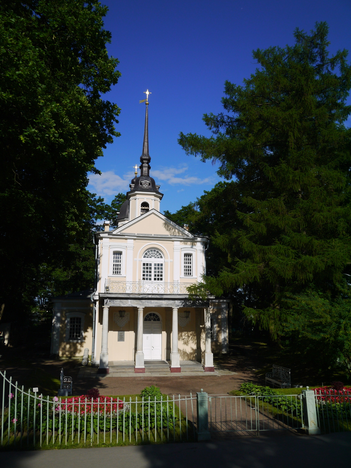 a church in front of a white picket fence