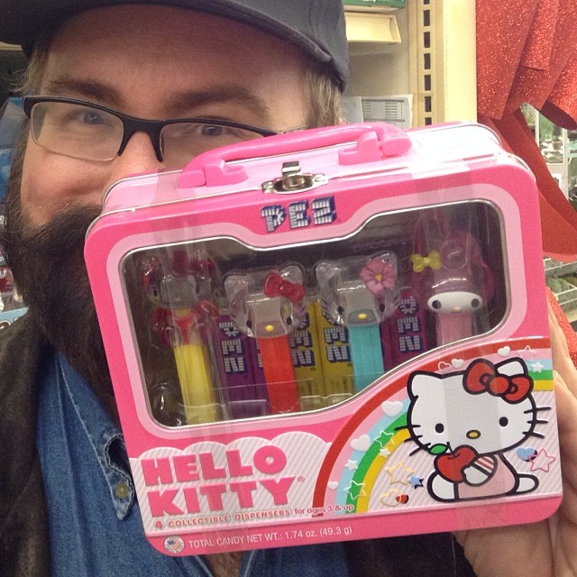 man holding a hello kitty case with colorful crayons in it