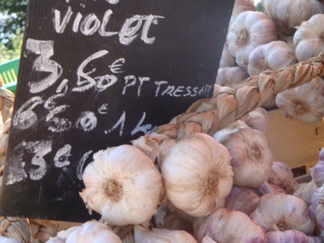 a display with garlic on top for sale