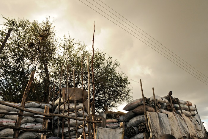 the wood is stacked and next to the metal fence