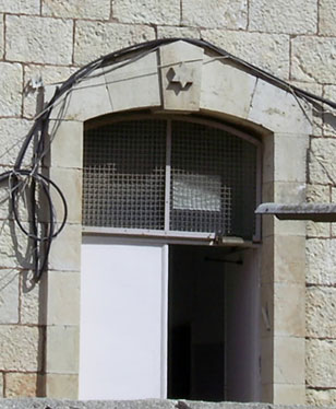 a building with an iron door and window