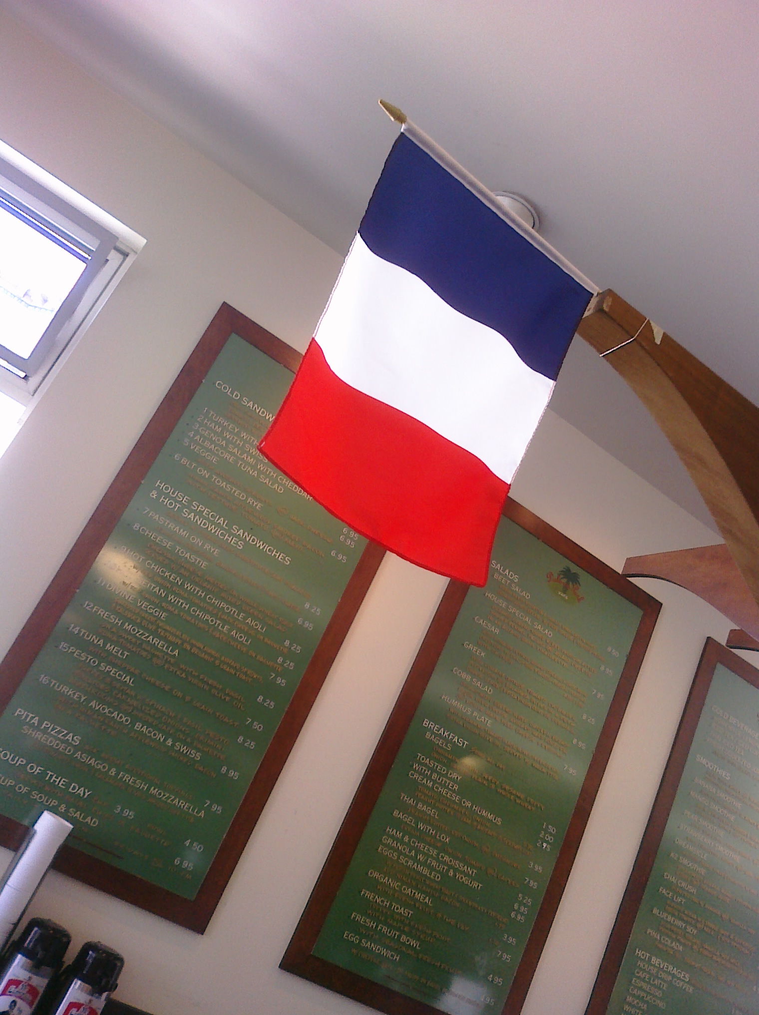 an american and french flag is on display next to green menus