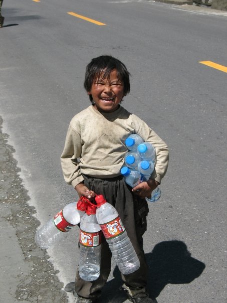 a  is holding two large bottles