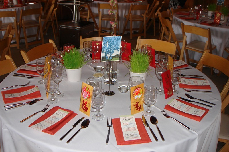 a table with white linen covered tables and chairs