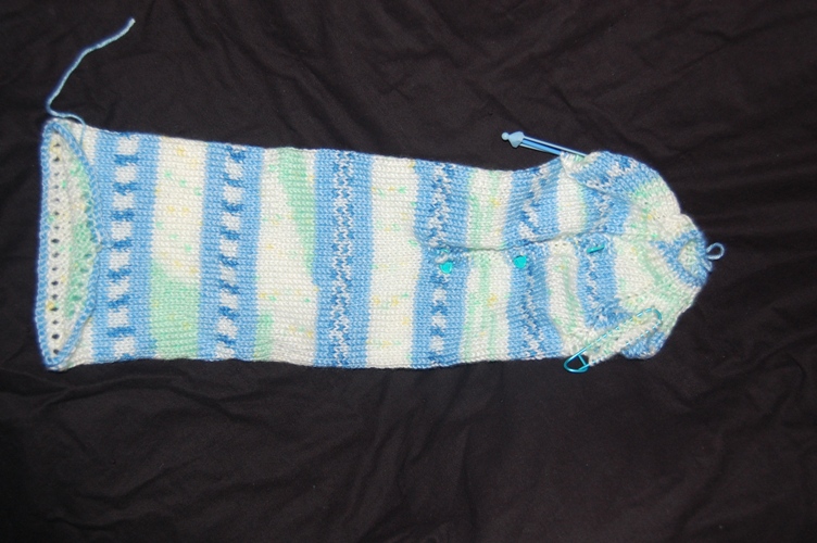the knitted arm warmer is lying on top of the fabric