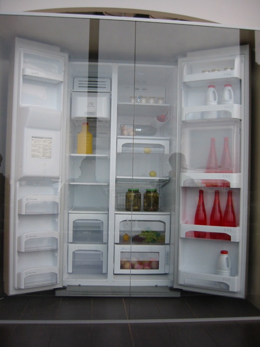 a refrigerator with two doors open in the room