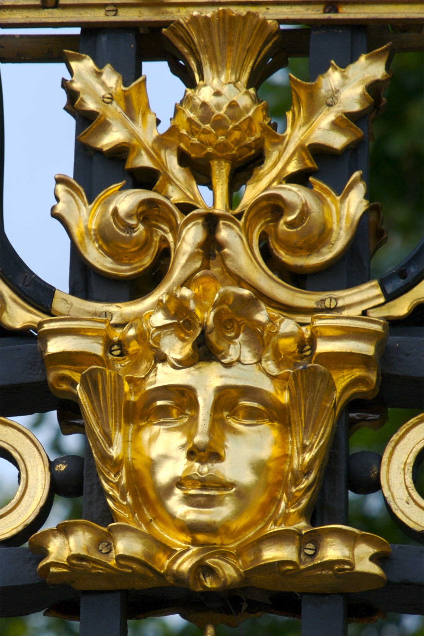 a close up of a clock with decorative gold decoration