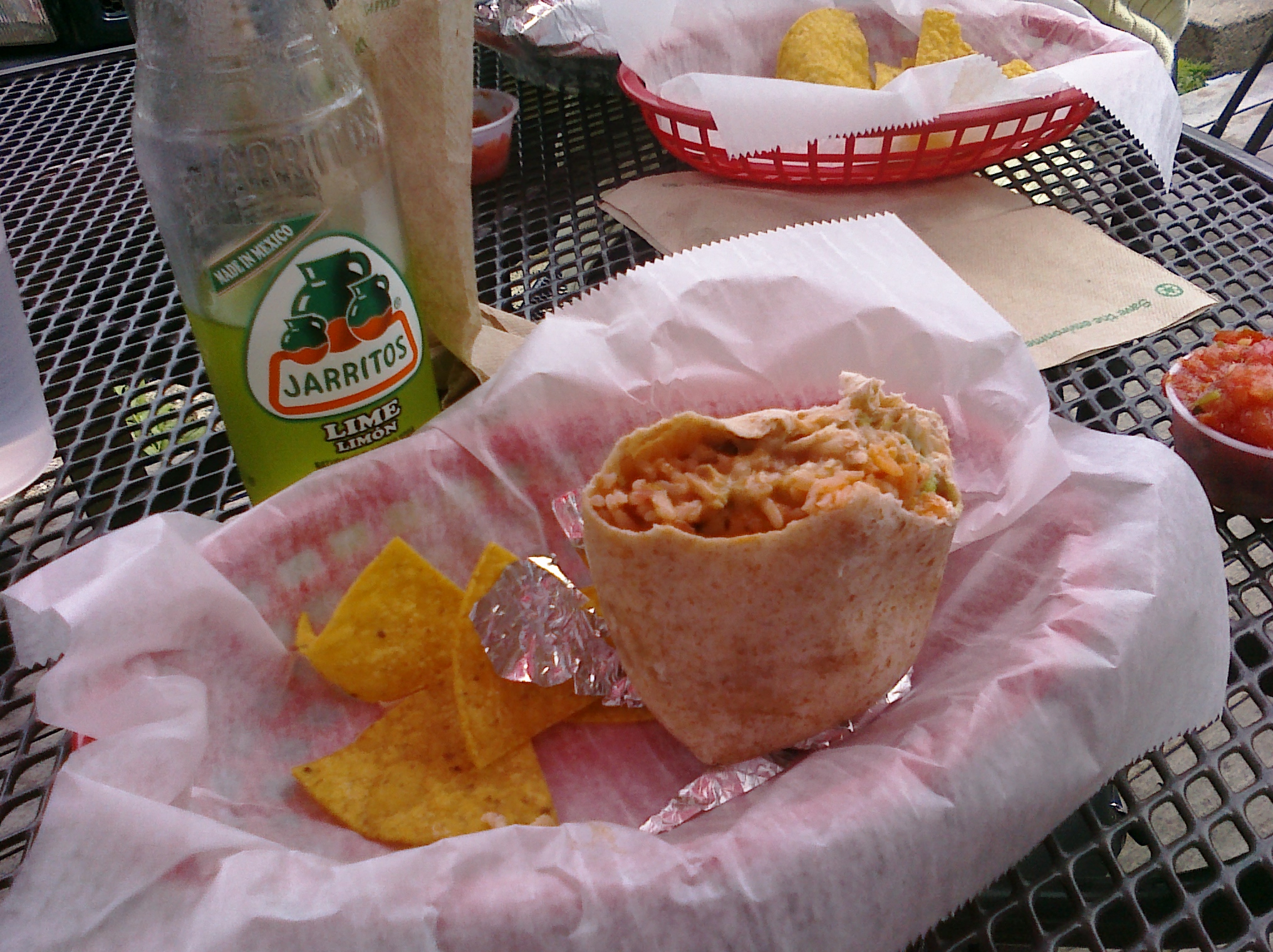 a close up of a tortilla on a table near other food