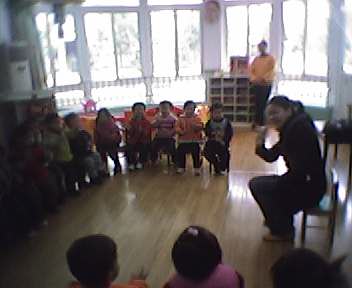 a man standing in front of a crowd of children