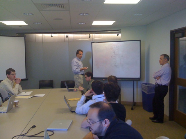 several men are in a business meeting with computers