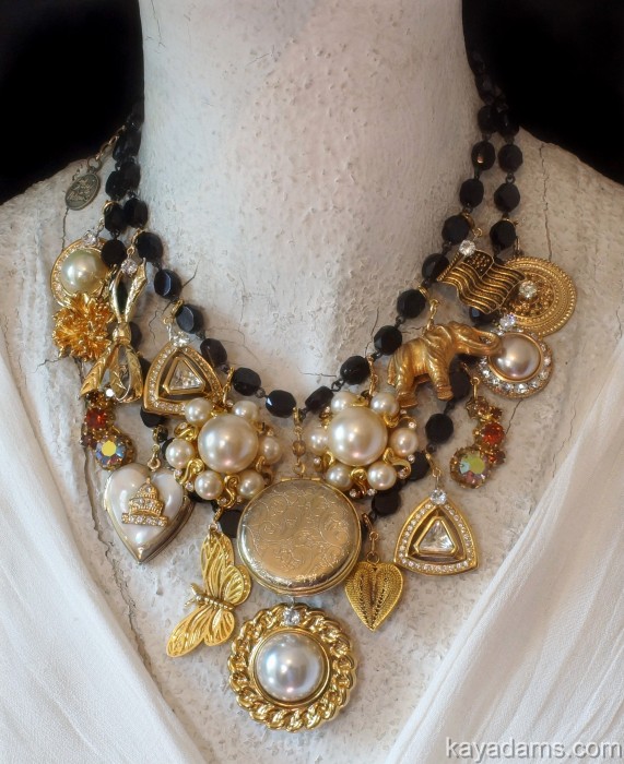 a gold and black necklace with other jewels