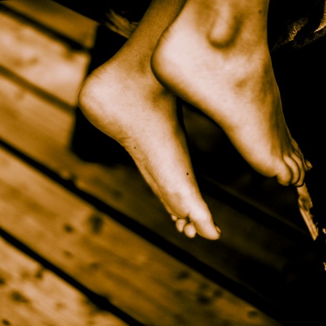 a person sitting on a bench near the wooden floor