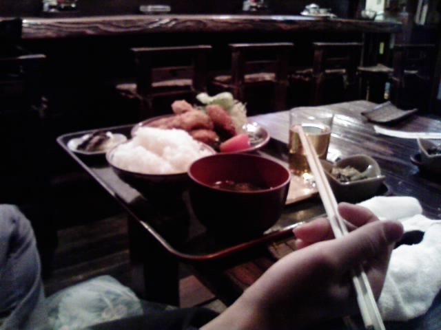 someone is holding chop sticks over the table