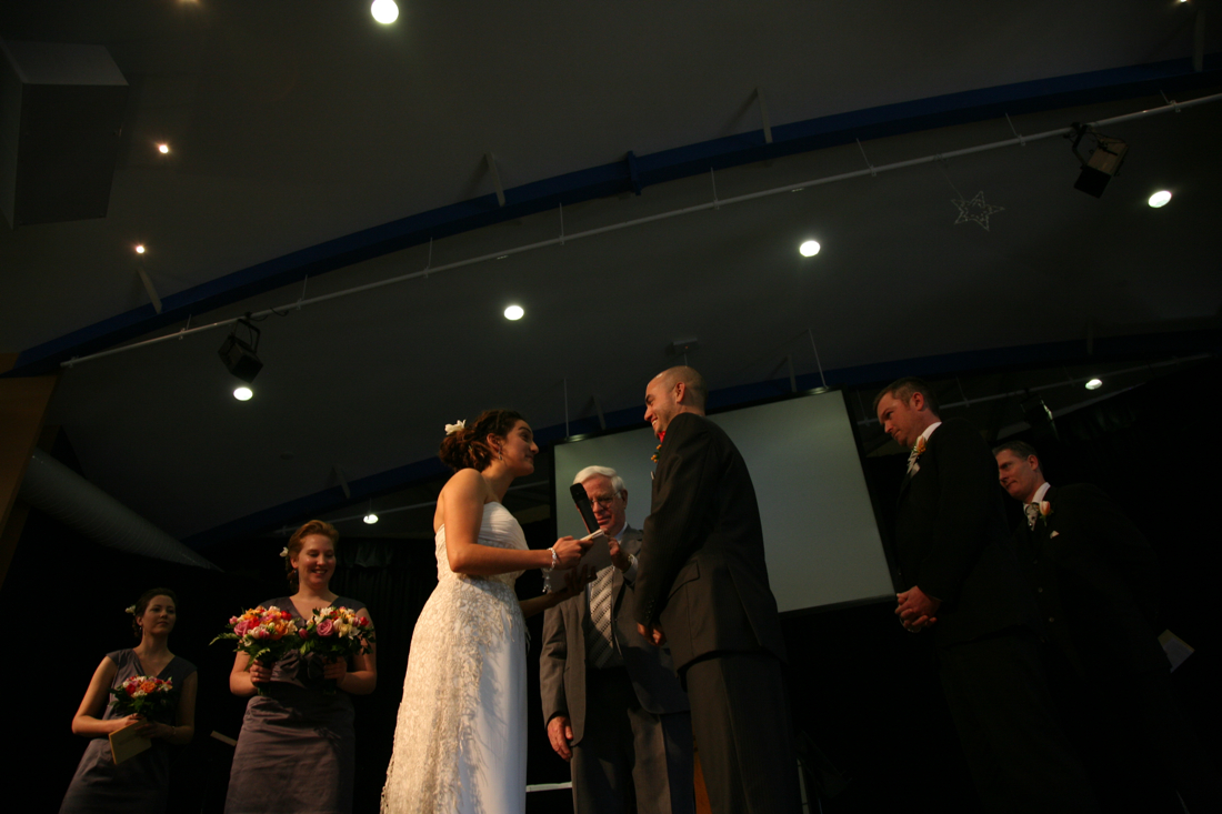 a bride and groom exchanging vows at their wedding ceremony