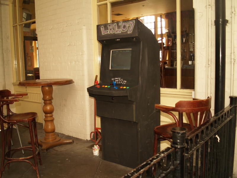 an old fashioned vending machine sitting outside of a restaurant