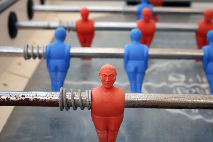 several small plastic figurines sitting on a metal frame