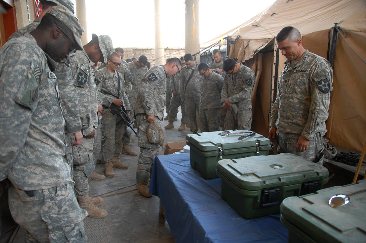 soldiers stand with their bags near some boxes