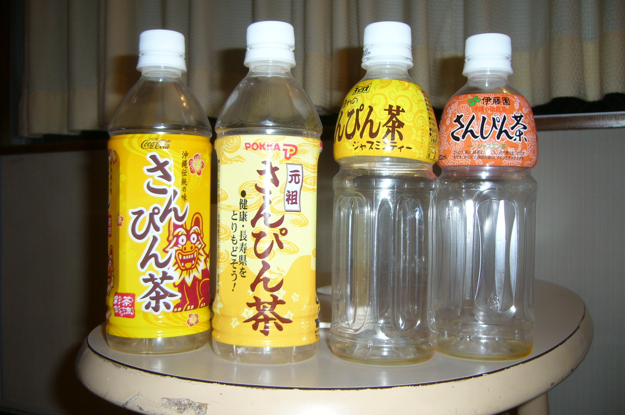 four japanese water bottles with asian writing on them