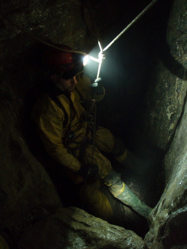 a fireman kneeling in the dark of a tunnel
