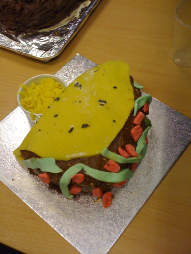 a cake with yellow frosting on top of it