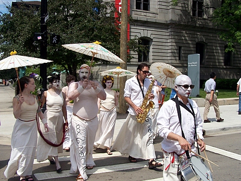 some people are walking on the street holding umbrellas