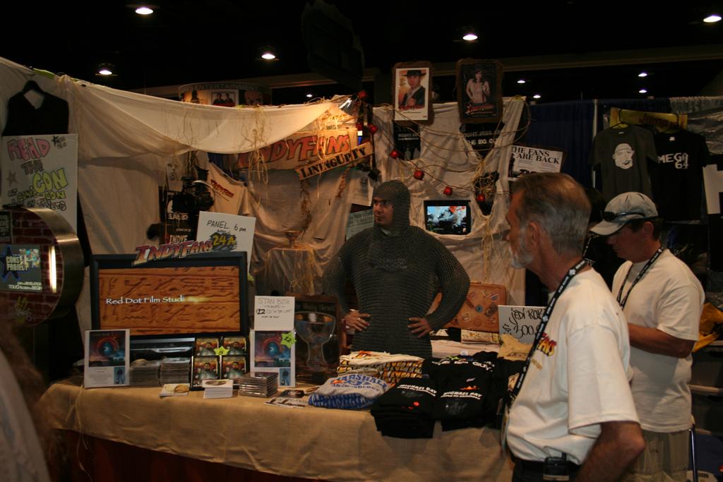 men shopping for jewelry and home goods at an outdoor convention