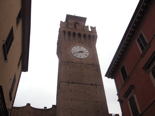 a tall clock tower standing above an old building