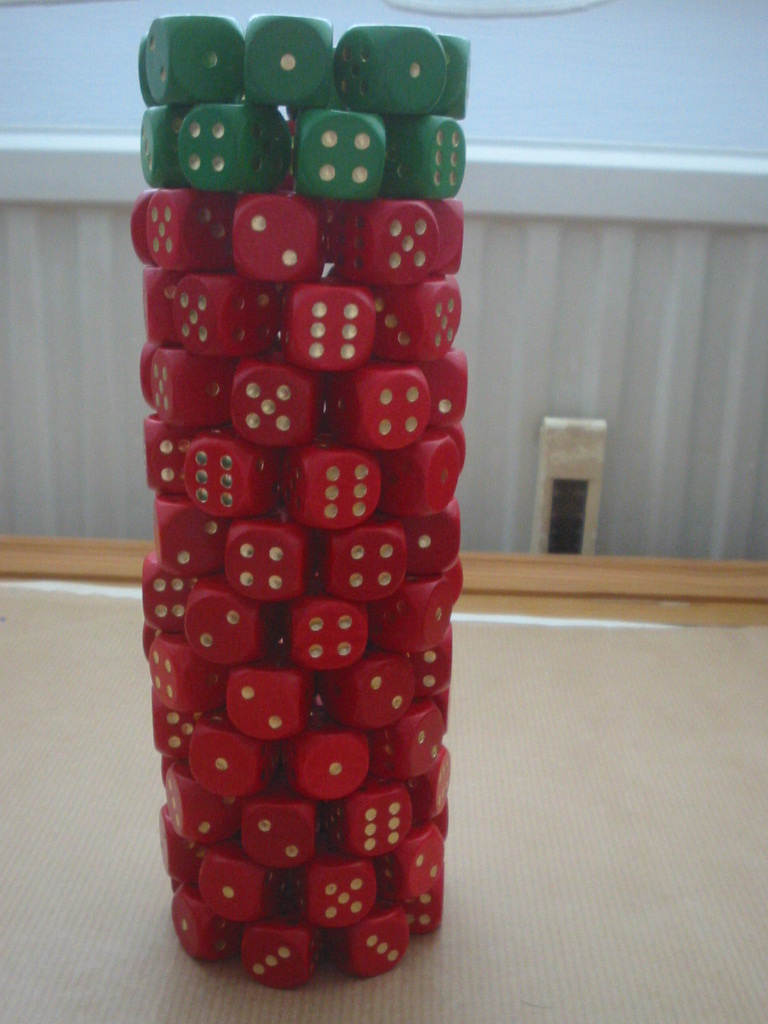 a large stack of red dices next to a window