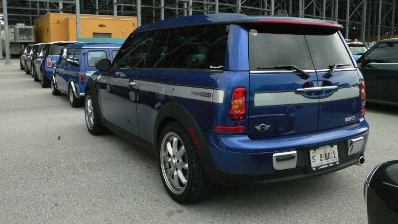 a blue suv is parked in front of other cars